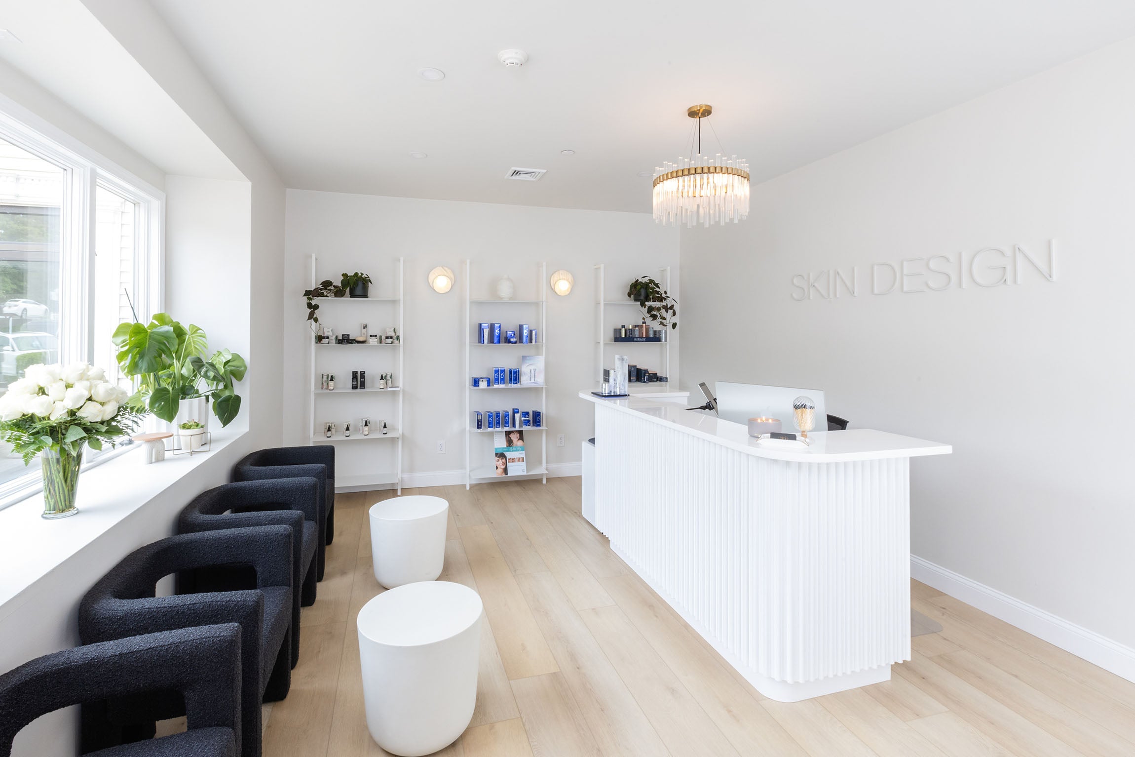 Skin Design Aesthetics Medical Spa in South Shore, MA waiting room with chairs and skincare on the far wall