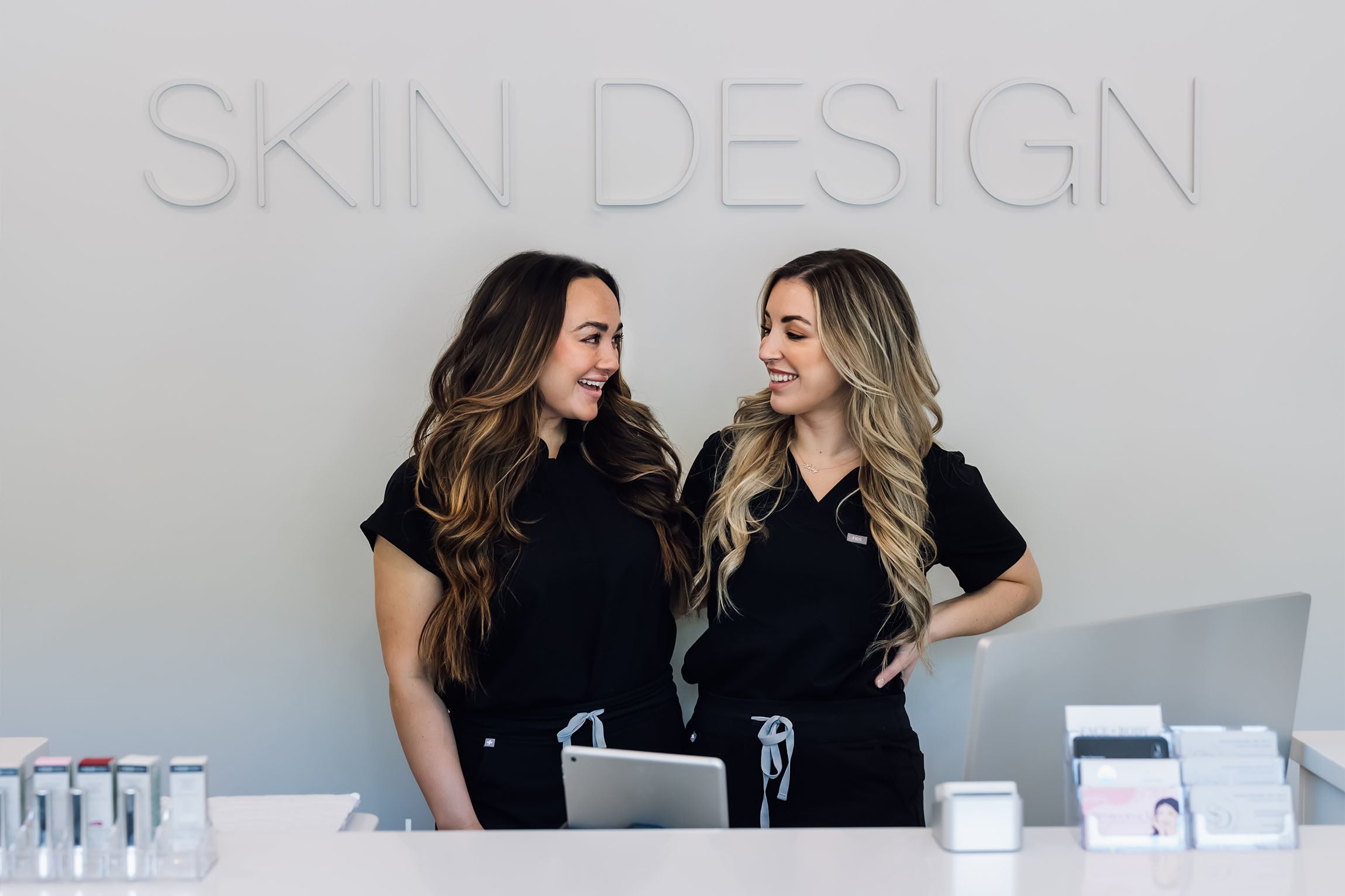 Jacquelyn Curran and Kristina Borrelli at front desk of Skin Design Aesthetics